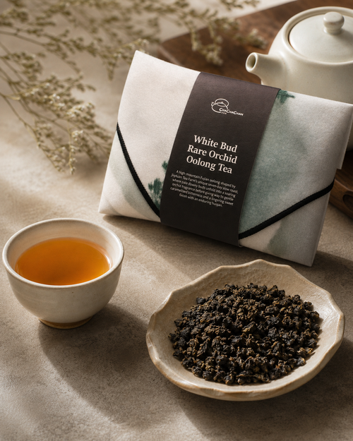 Gift tea set for the 'White Bud Orchid Oolong Tea' from Cha Cha Chan, featuring a packet of loose tea leaves, a postcard, and a reusable magic wrap.